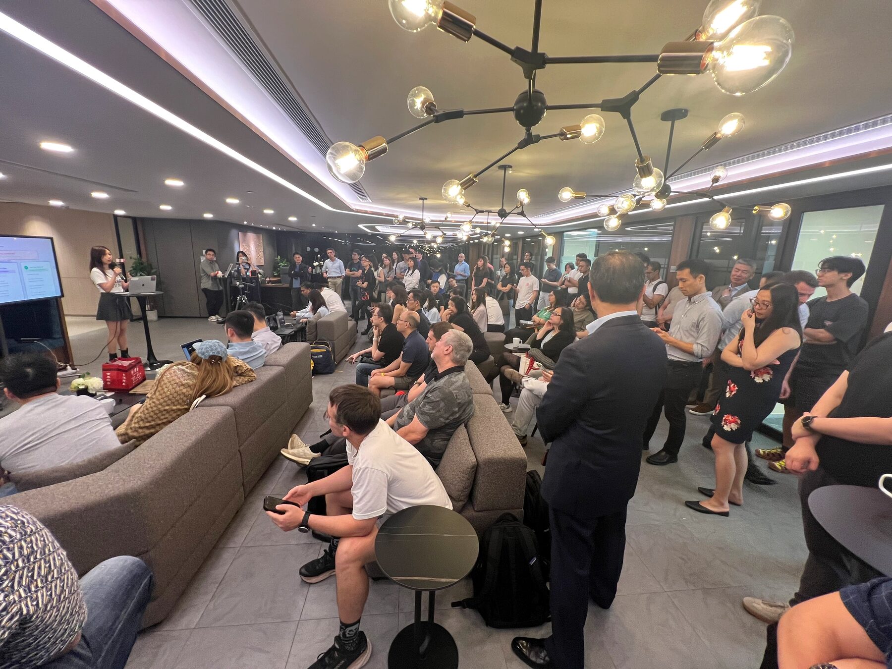 Audience watching a live AI Trading demo from the back of the room